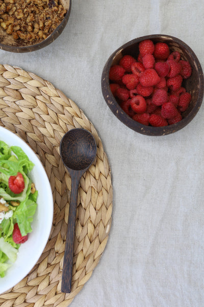 Meal set up with the sugar palm wood spoon next to a salad